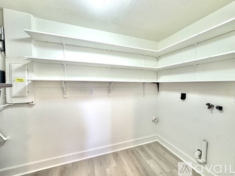 A kitchen with white cabinets and a white ceiling.