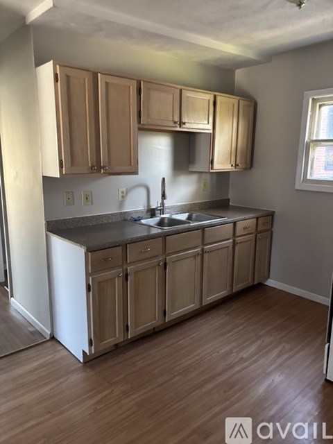 A kitchen with wooden cabinets and a white refrigerator.