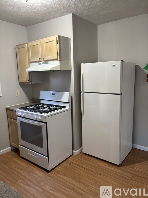 A kitchen with a stove, oven, and refrigerator.
