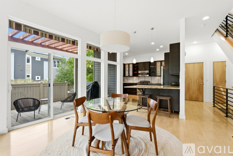 A modern dining room with a glass table and chairs.
