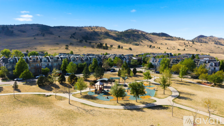 A bird's eye view of a residential area with houses and a playground.