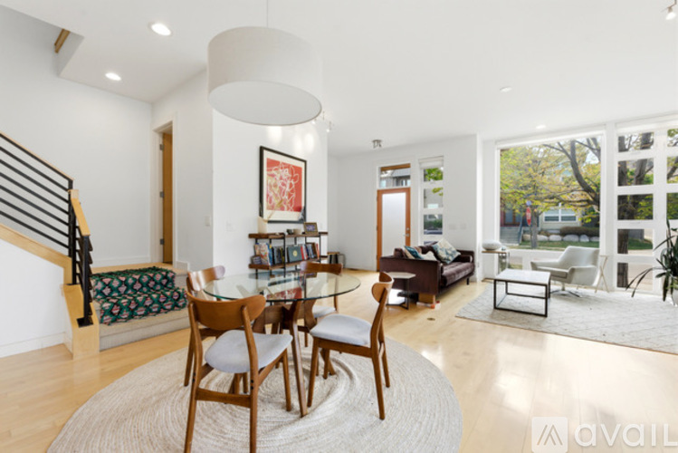 A living room with a glass table and chairs.