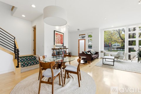A living room with a glass table and chairs.