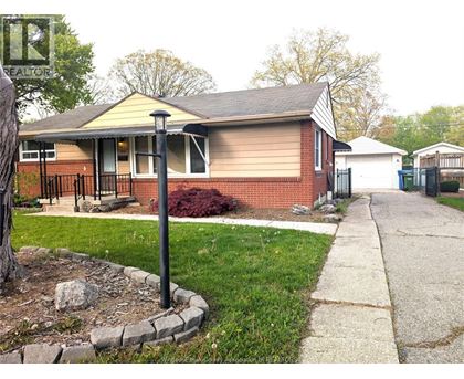 A house with a red brick exterior and a white garage door.