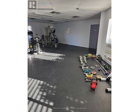 A room with a gym and exercise equipment.