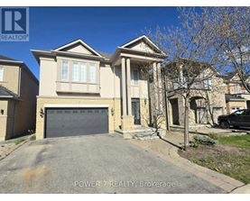 A house with a grey garage door is for sale.