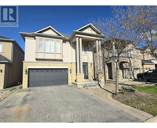 A house with a grey garage door is for sale.