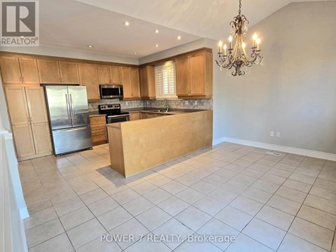 A kitchen with wooden cabinets and a refrigerator.