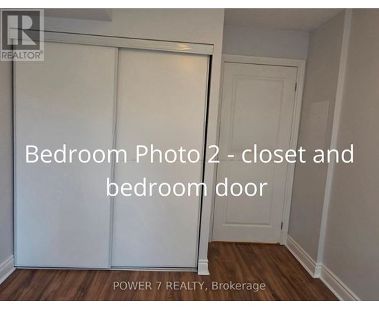 A bedroom photo showing a closet and a bedroom door.