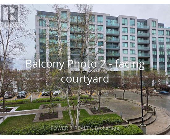 A view of a courtyard with a building in the background and the text "Balcony Photo 2 - facing courtyard" overlaid on the image.