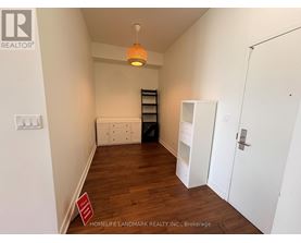 A room with a white door, a white cabinet, and a white shelf.