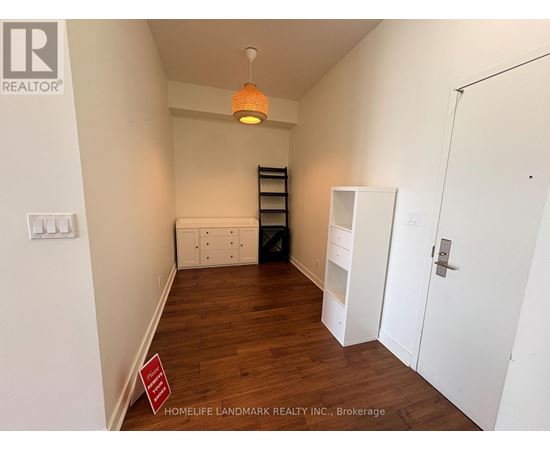 A room with a white door, a white cabinet, and a white shelf.