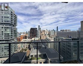 A cityscape with buildings of various heights and a clear sky.