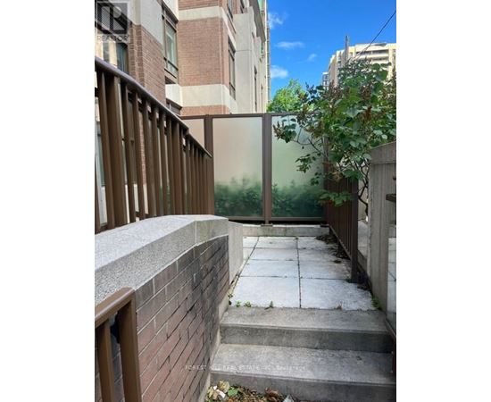 A view of a staircase leading to a glass door.