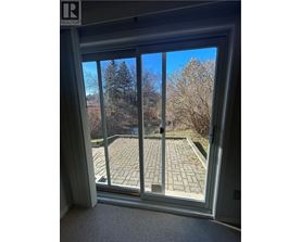 A view of a patio through a sliding glass door.