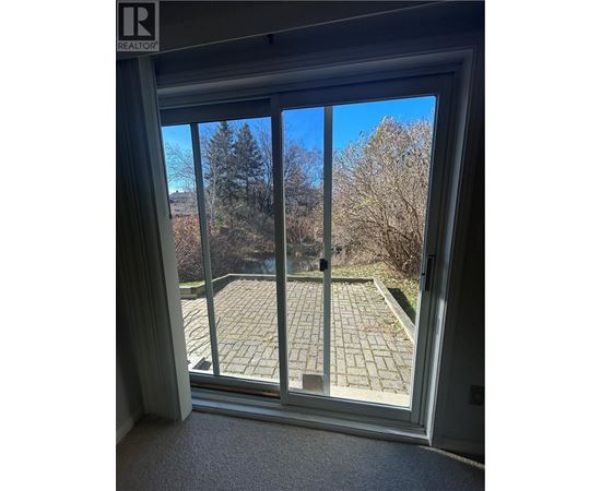 A view of a patio through a sliding glass door.