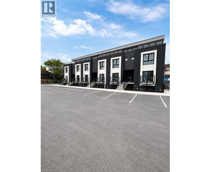 A building with a parking lot in front of it.