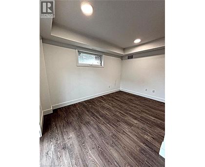 A room with wood flooring and a window.