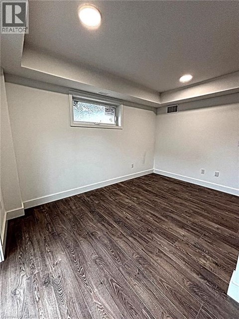 A room with wood flooring and a window.