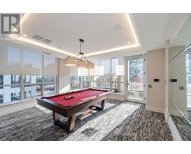 A pool table in a room with a view of the city.