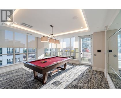 A pool table in a room with a view of the city.
