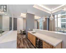 A modern kitchen with wooden cabinets and a large island.
