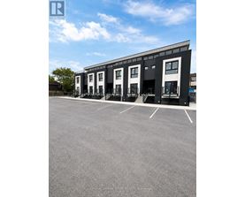 A parking lot in front of a building with a sign that says REALTOR.