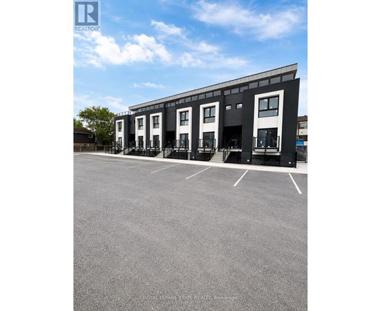 A parking lot in front of a building with a sign that says REALTOR.