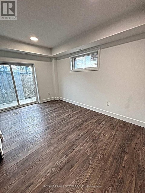 A room with wooden flooring and a window.