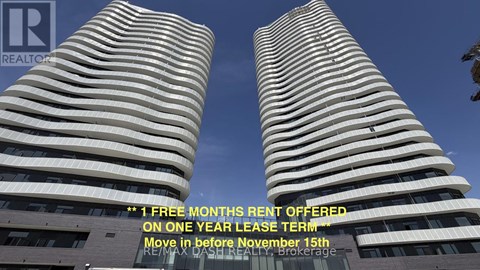 Two tall buildings with a sign offering a free month's rent on a one year lease term.