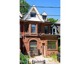 A house with a red brick facade and a white roof with a black gutter.