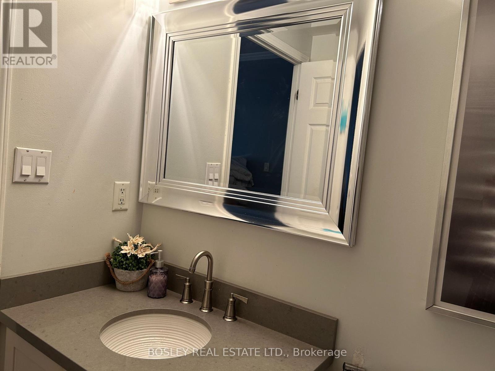 A bathroom sink with a large mirror above it.