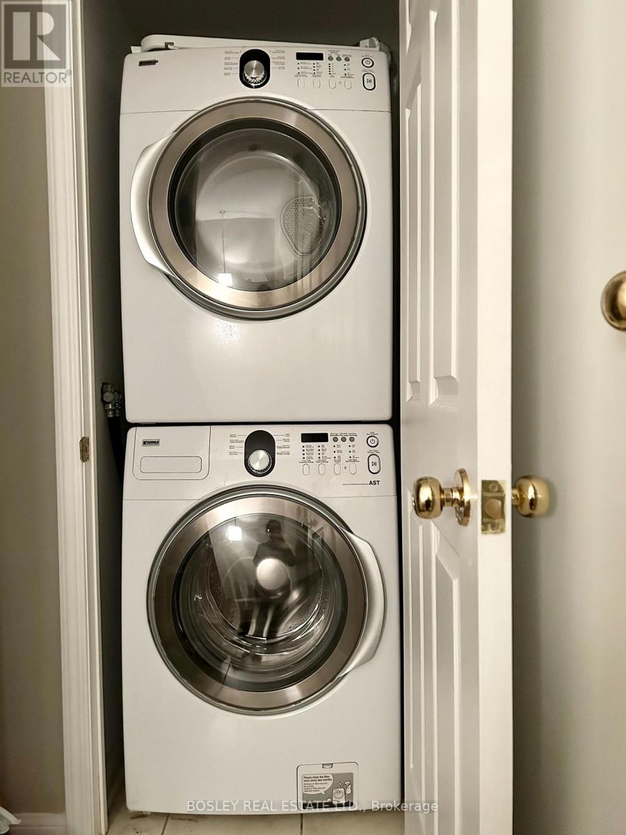 Two front load washing machines in a small space.