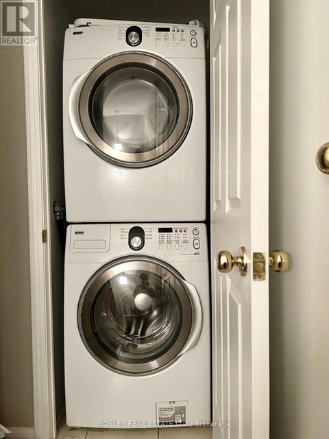 Two front load washing machines in a small space.