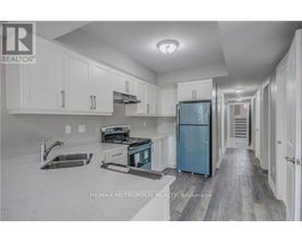 A kitchen with white cabinets and a blue refrigerator.