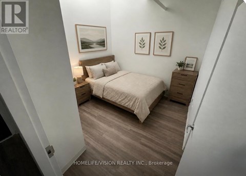 A bedroom with a bed, nightstand, and two framed pictures on the wall.