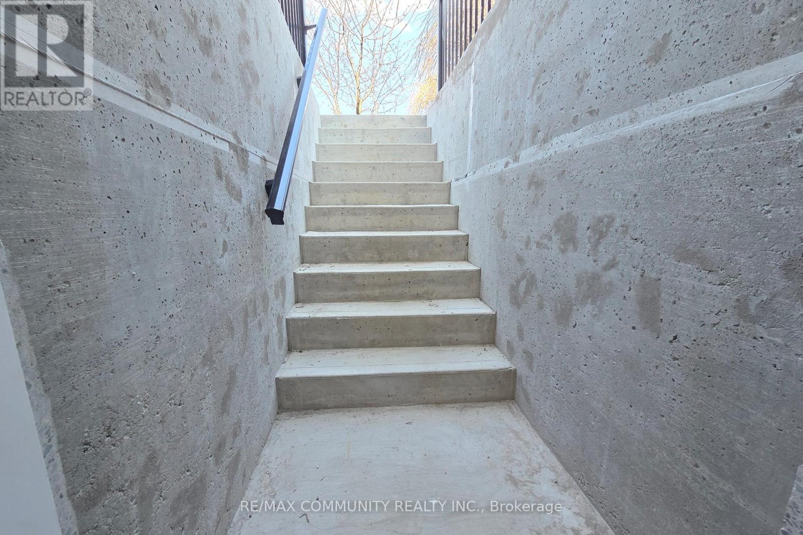 A concrete staircase with a metal railing.