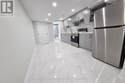 A modern kitchen with a stainless steel refrigerator and marble flooring.