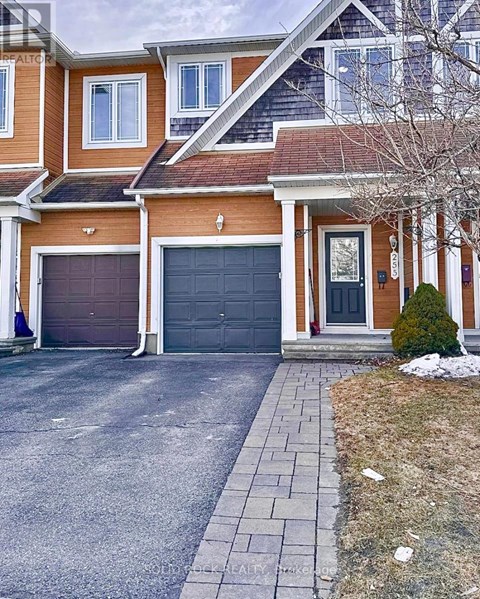 A two-story house with a garage and a driveway.