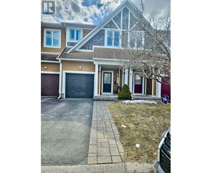 A house with a garage and a driveway in front.