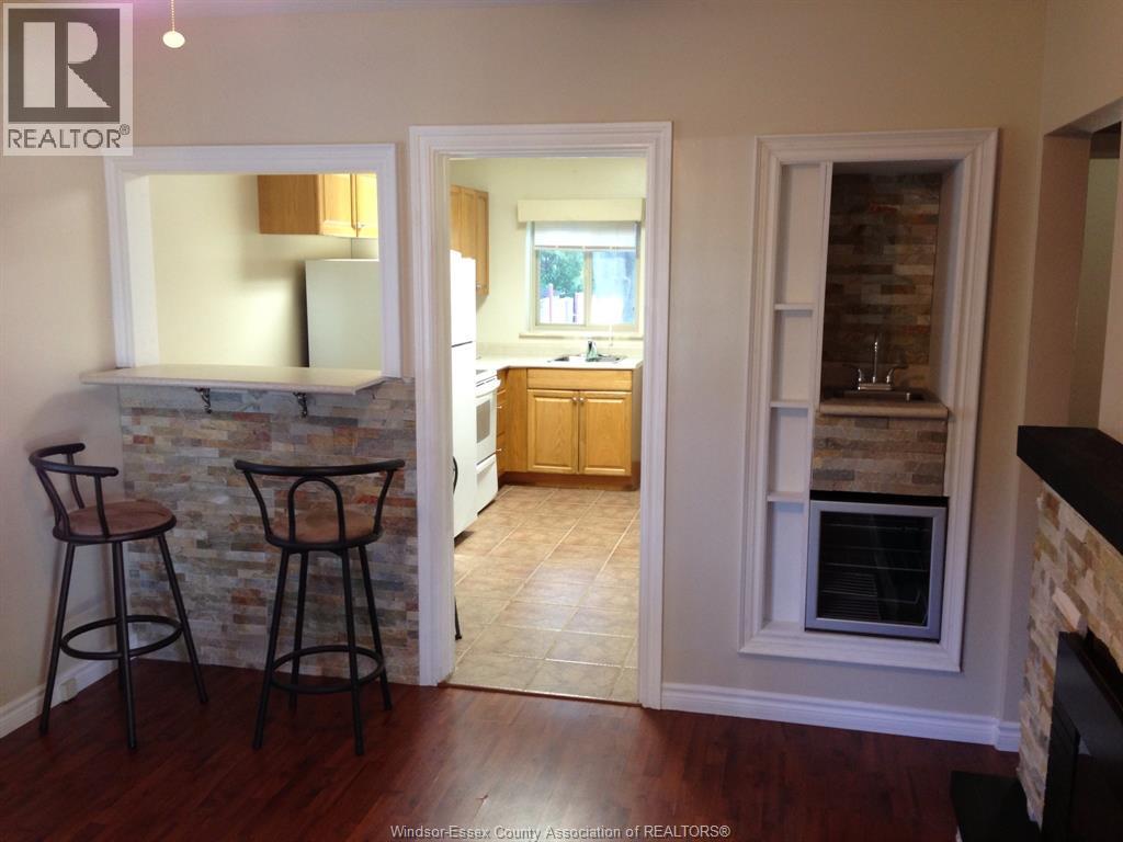 A realtor's photo of a kitchen and living room interior.