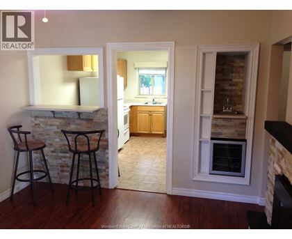 A realtor's photo of a kitchen and living room interior.