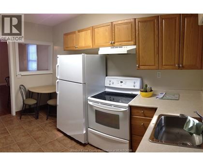 A kitchen with a white refrigerator and stove.