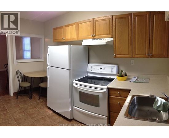 A kitchen with a white refrigerator and stove.