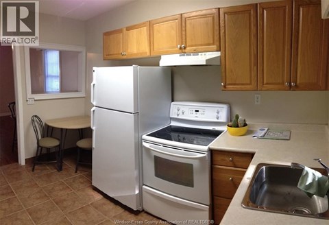 A kitchen with a white refrigerator and stove.