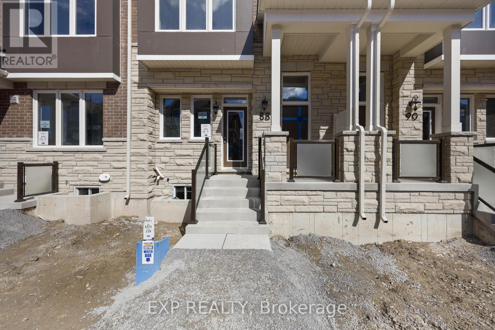 A house under construction with a sign that says EXP REALTY Brokerage.