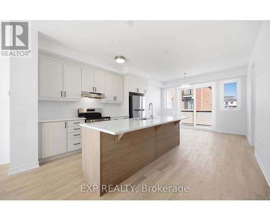 A kitchen with white cabinets and a wooden island.