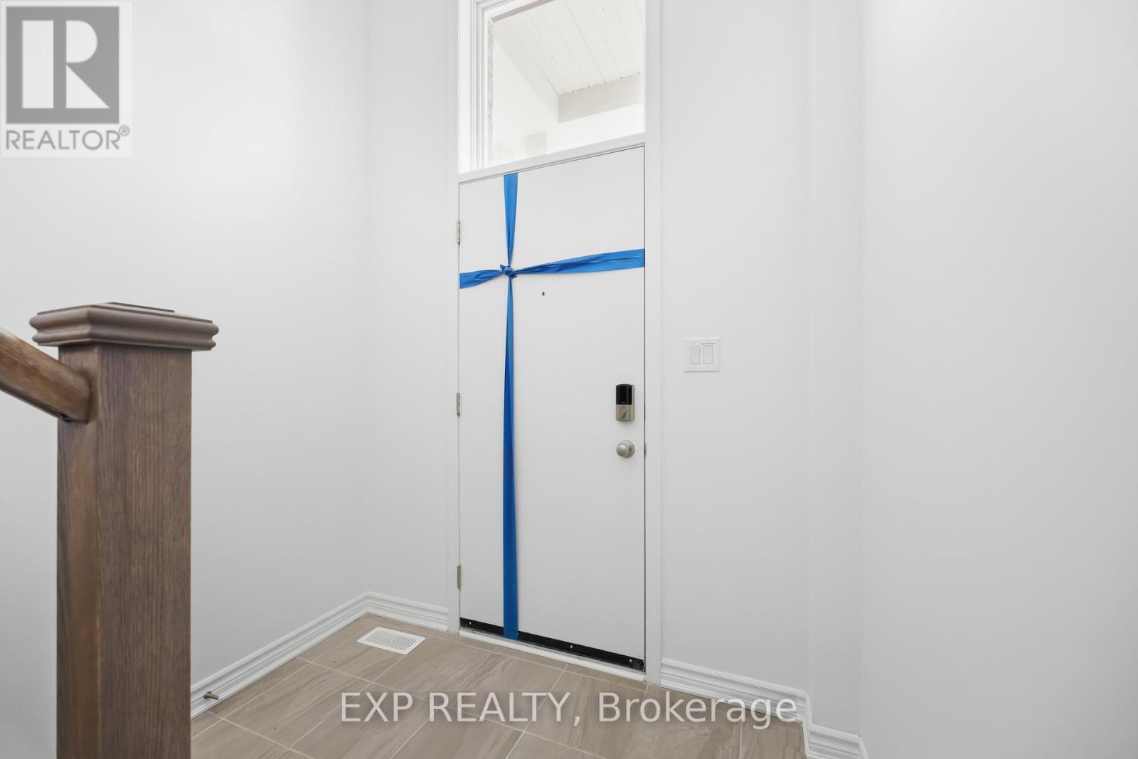 A white door with blue tape on it in a room.