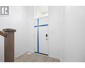 A white door with blue tape on it in a room.