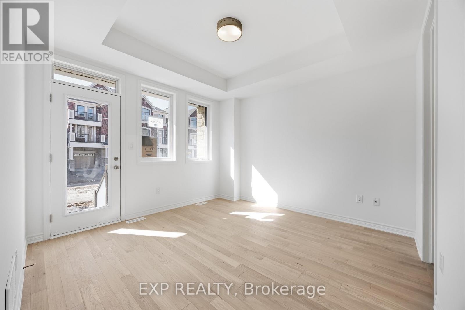 A room with EXP REALTY, Brokerage written on the floor.